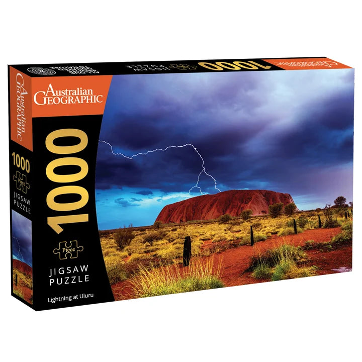 Australian Geographic 1000-piece jigsaw puzzle box featuring a dramatic lightning scene over Uluru.