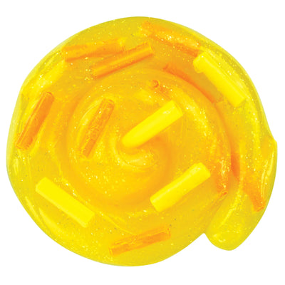 A round, yellow translucent gel or slime-like product with glitter and small orange and yellow stick-like inclusions, shown on a plain white background.