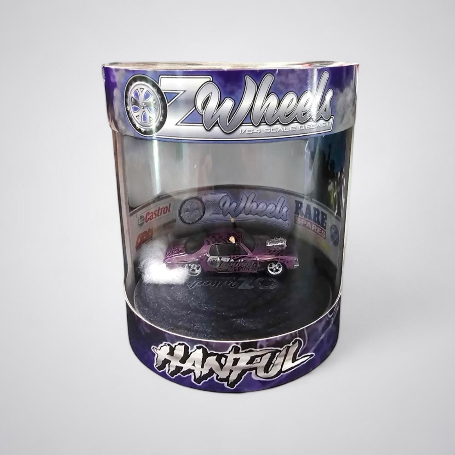 A 1:64 scale model of an OZ Wheels Hanful Monaro skid cylinder in purple color, housed in a clear plastic container with a brand logo and graphics.
